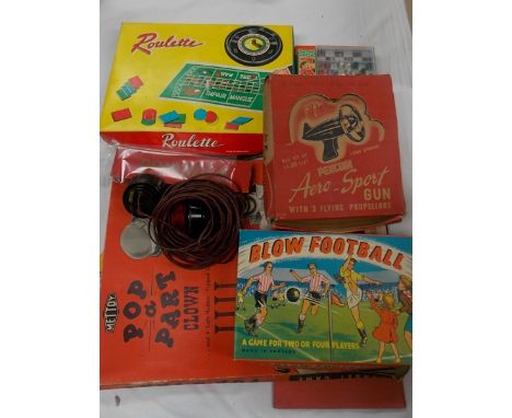 Collection of vintage board games including a Penguin Aero-Sport gun with three flying propellers in original box.