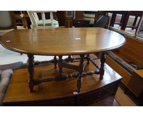 An Ercol medium elm drop leaf gateleg coffee table.