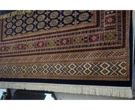 A Bokhara carpet on a mainly blue ground, the central panel with multiple lozenges flanked by multiple geometric border, 280x