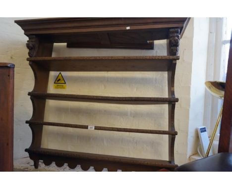 A 20th Century oak hanging shelf in the Flemish style.