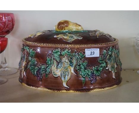 A 19th Century Wedgwood Majolica game pie bowl and cover, having relief decoration depicting dead game, foliate and grapes wi