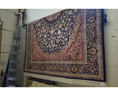 A good quality Keshan carpet, decorated and stylised motifs on a predominately blue ground, approx 3.80x2.00