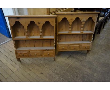A pair of pine hanging shelf units, each with three base drawers