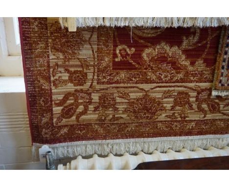 A Zeigler carpet on a mainly red ground, the central panel with multiple floral decoration, flanked by multiple florally deco