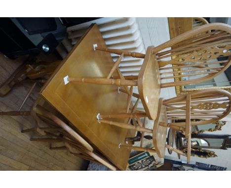 A 20th Century light oak dining suite comprising draw leaf table and four chairs.