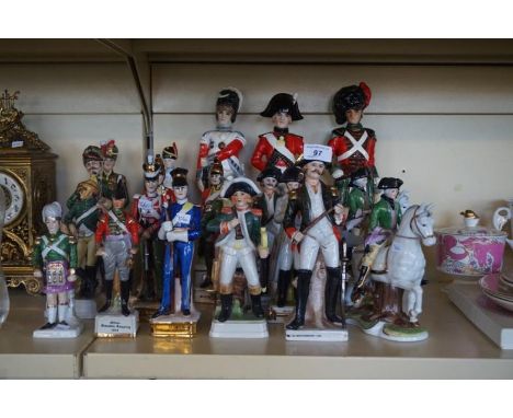 Twenty assorted continental ceramic models of officers and soldiers.