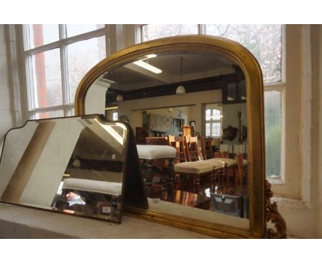 A modern gilt frame over mantel wall mirror.