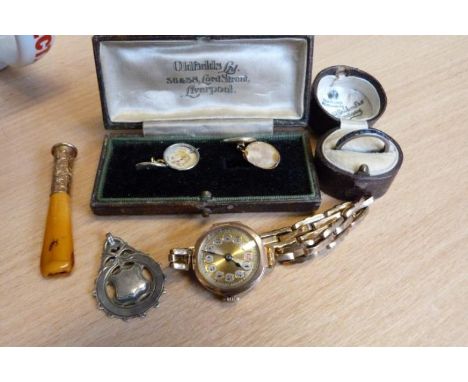 An early 20th century ladies 9ct gold manual wind wrist watch, to an expandable strap, together with, a 9ct gold cigarette ho