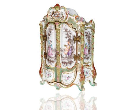 moulded as a rocaille-scrolled dresser, the interior with three stacked shelves decorated with Deutsche Blumen and gilt-edgin