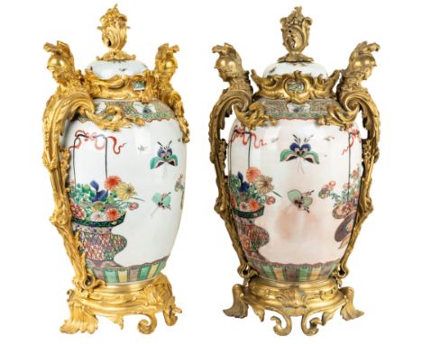 of bulbous ovoid form, finely painted overall with flower baskets and butterflies with scrolling decoration, the bodies with 
