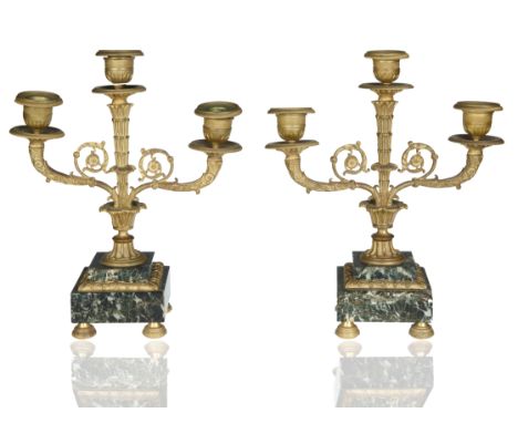 a pair of three-light candelabra with scrolling ornaments, atop square verde antique bases; overall height of each: 28.5 cm (