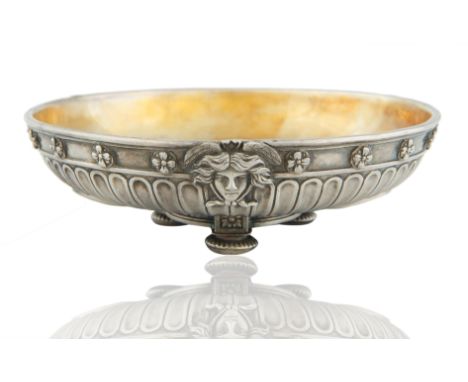 the body fluted, with banded rim decorated with four-leaf flowers and set with three angels' heads, the gilt interior set wit