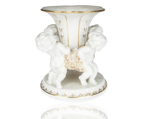 tulip form with gilt-edging and relief, the centerpiece held by four putto with gilt stylized flowers, atop a circular gilt-e