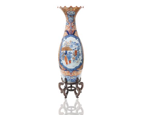 baluster the neck flares to a rippled edge, the bodies of each decorated in blue and red accented by white featuring garden s