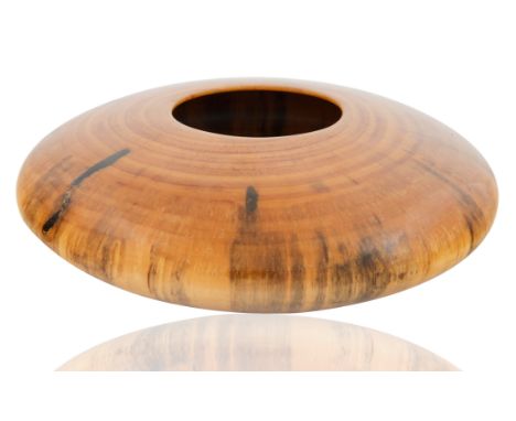 disk form, the body with the organic wood grain, the natural coloring of gold and orange hues accented with dark and light br