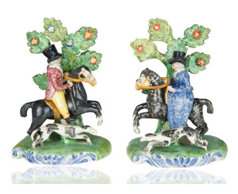 each modelled atop a naturalistic base, the gentleman and lady atop respective horses accompanied by a hound, dressed in vict