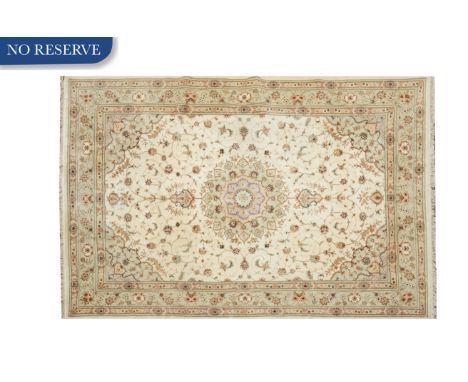 a large area rug of Verona-style with a centered floral medallion and conforming design of floral sprays against an ivory gro