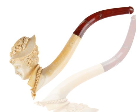 a Victorian woman's head carved from meerschaum, adorned with a hat and accessories with bakelite stem and mouthpiece, housed