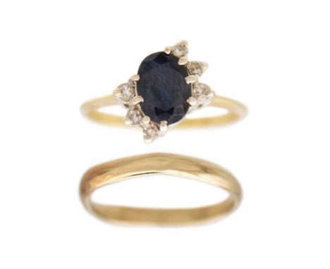 An 18k gold dark blue sapphire and diamonds ring and 9k gold band ring Hallmarked import Birmingham 750, has six accent diamo