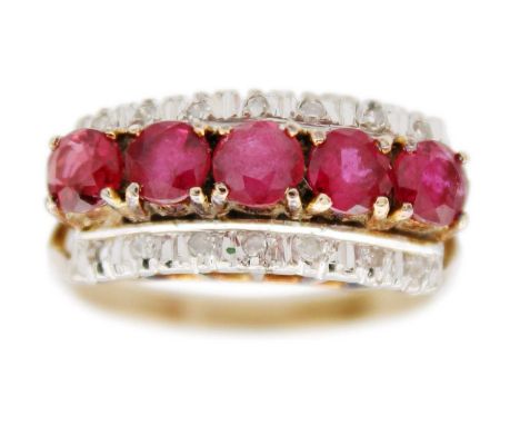 A 14ct ruby and diamond set ring. Set with a row of five round cut rubies each of 0.20ct, and a flanked by a two rows of smal