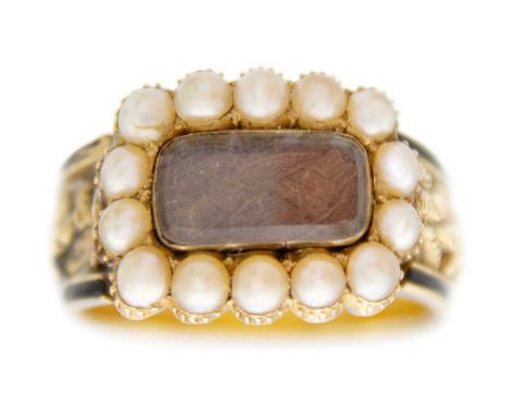A George IV 18ct hallmarked gold and black enamel seed pearl set memorial ring. The oblong head with a glazed hair panel surr