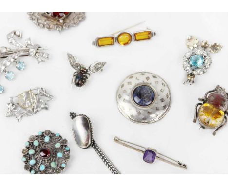 A collection of eleven silver and white metal brooches. Including a boulder opal, seed pearl set flying insect brooch, width 