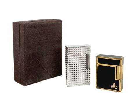 S. T. DUPONT - Two lighters. One in a chrome nickel case, with box and papers, the other gold plated with black enamel.The bl