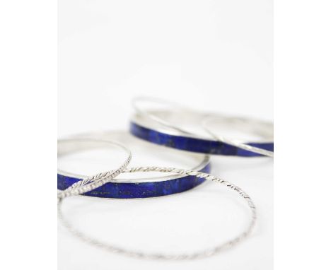 A selection of silver bangle bracelets Two bangles are inlayed with lapis lazuli .Good used condition,  no breakages,  no chi