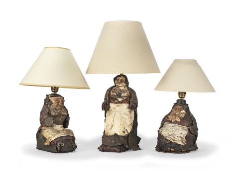 Three early 20th century Mexican moulded composition and leather figural bottle table lampsFitted for electricity. Comprising