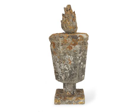 A carved limestone parapet urnOf canted pedestal form with flambé finial on square base, 19cm wide, 19cm deep, 47cm high (7in