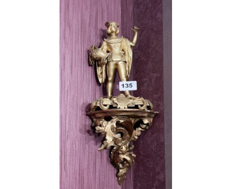 A 19th century gilt bronze figure of a young squire carrying his knight's helmet, H. 20cm. together with a 19th century carve