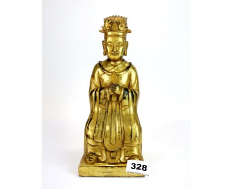 A Tibetan gilt bronze figure of a seated deity, H. 24cm.