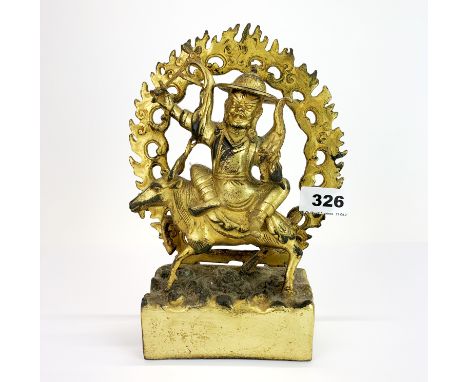 A Tibetan gilt bronze figure of a Buddhist deity, H. 23cm.