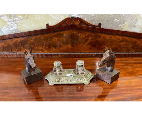 A Victorian brass desk stand with cut glass ink wells and a pair of horse head desk decorations, desk stand W. 30cm.