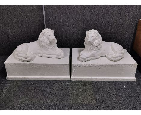 A pair of large vintage painted concrete reclining lions on painted wooden pedestals, pedestal size 79 x 46cm, overall H. 57c