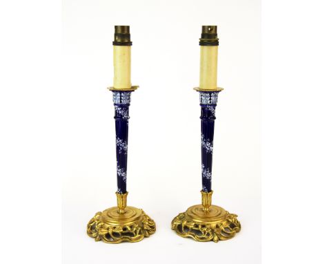 A pair of Omalu mounted porcelain candlestick style table lamps (currently not wired for use), H. 35cm.