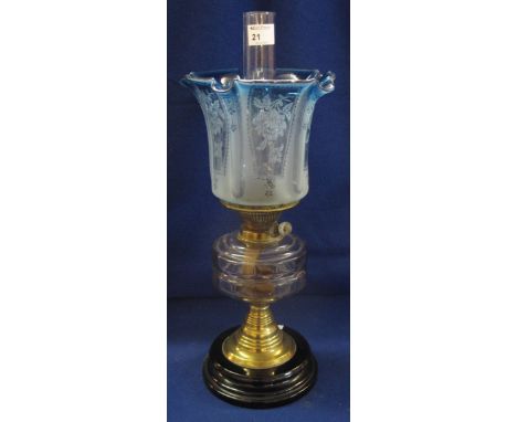 Early 20th Century brass double burner oiler lamp, having glass reservoir, brass column and ceramic base, together with etche