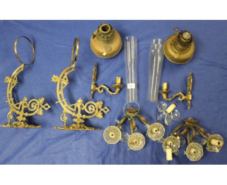 Box containing assorted brass oil lamp sconces together with oil burners and funnels and glass candelabrum.
