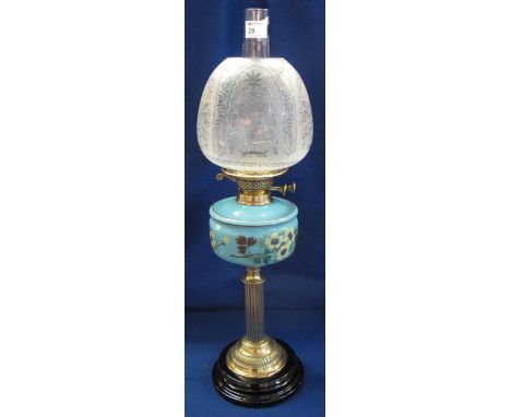 Early 20th Century brass double burner oil lamp having ceramic, floral painted reservoir on brass pedestal with ceramic base,