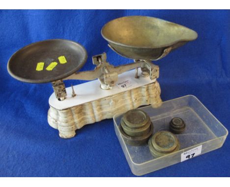 Small set of white enamelled and brass scales with a graduated group of assorted brass weights.