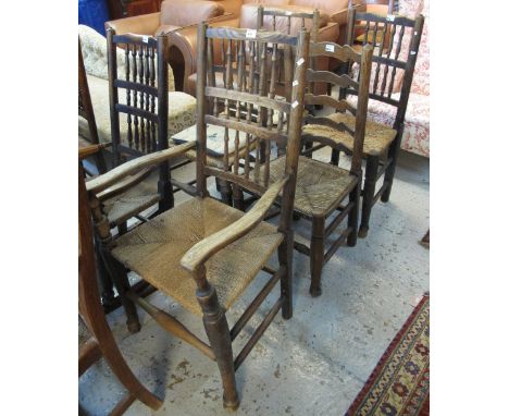 20th Century stained, spindle back rocking elbow chair with rush seat together with four similar stained spindle back chairs,