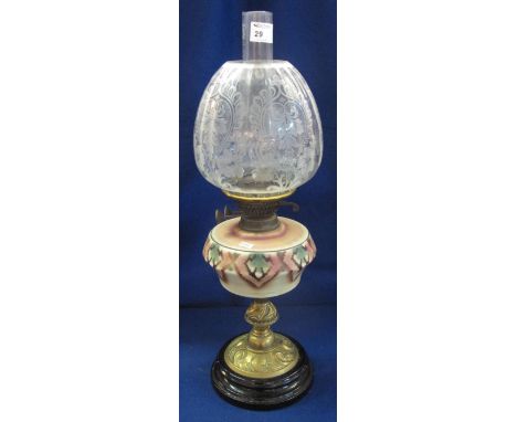 Early 20th Century brass double burner oil lamp having ceramic reservoir on repousse brass pedestal with ceramic base, etched