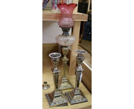 A Victorian oil lamp and a pair of plated candlesticks