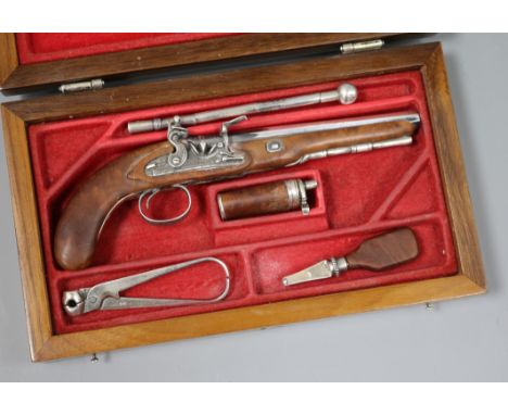 A Portuguese novelty 925 white metal mounted walnut model of a flintlock pistol with accessories, cased.