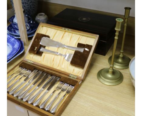 A pair of plated fish eaters, cormomandel and mother of pearl writing slope and pair of brass candlesticks