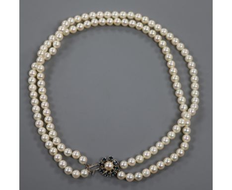 A double strand cultured pearl necklace with 14ct sapphire and cultured pearl set clasp, 42cm.