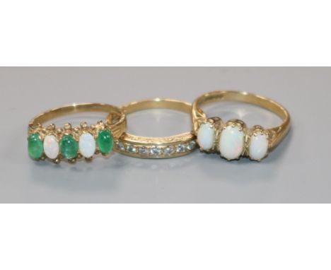 A 9ct gold cabochon emerald and opal five-stone half-hoop ring and two other 9ct gold rings, including an eight-stone diamond