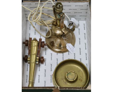 A Gimballed lamp, shell case, ashtray and brass cannon