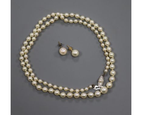 A Mikimoto single strand graduated cultured pearl necklace with white metal clasp, with box, together with a pair of cultured