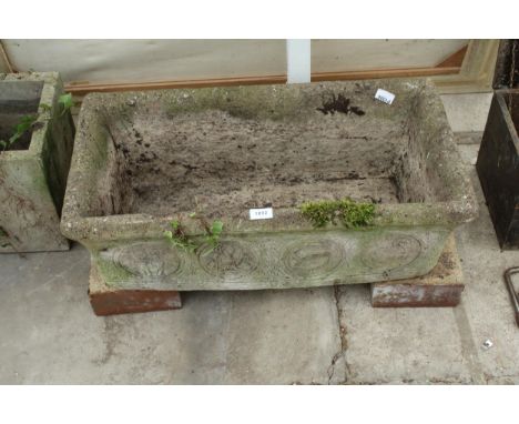 A CONCRETE GARDEN TROUGH PLANTER 